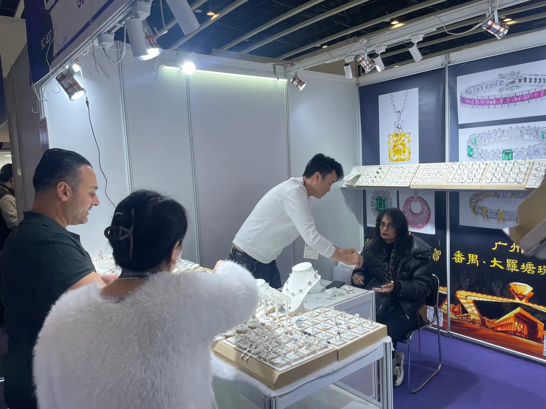 Zalson Jewelry representative discussing samples with buyers in Hong Kong