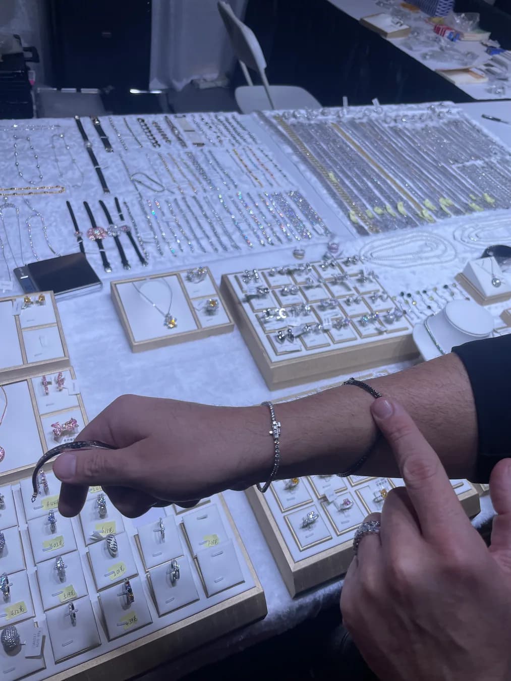 Buyer trying on a bracelet at the Zalson Jewelry Las Vegas booth